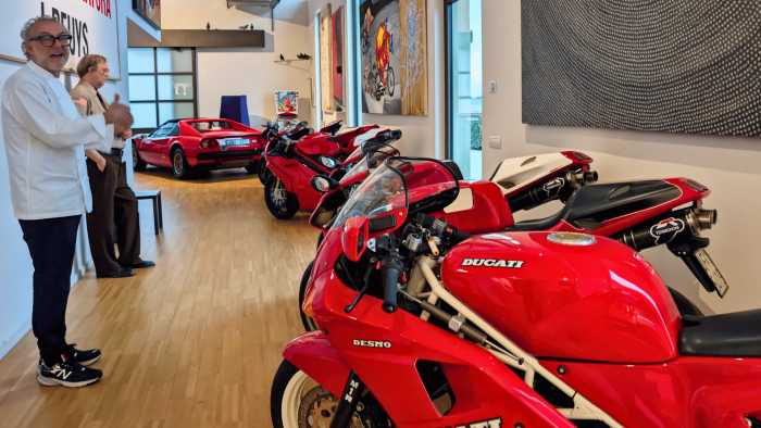 Chef Massimo Bottura giving a tour of his collection of fast bikes and cars